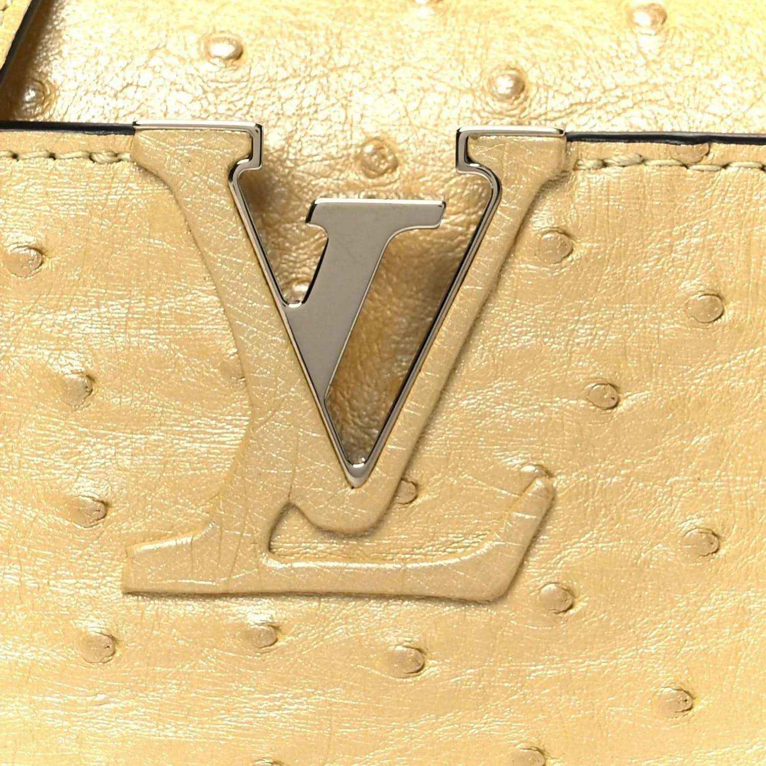Yellow ostrich-textured mini bag with large LV metal logo on front