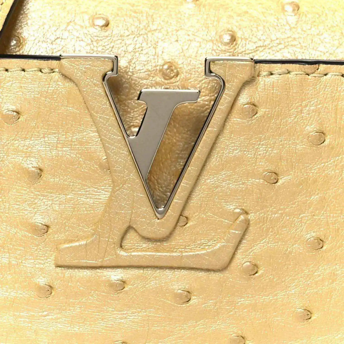 Yellow ostrich-textured mini bag with large LV metal logo on front