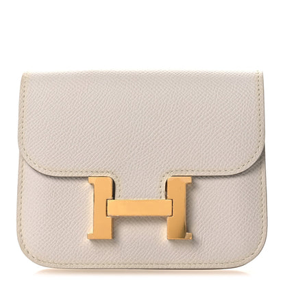 Pale gray leather slim wallet with centered gold-tone H clasp on front flap