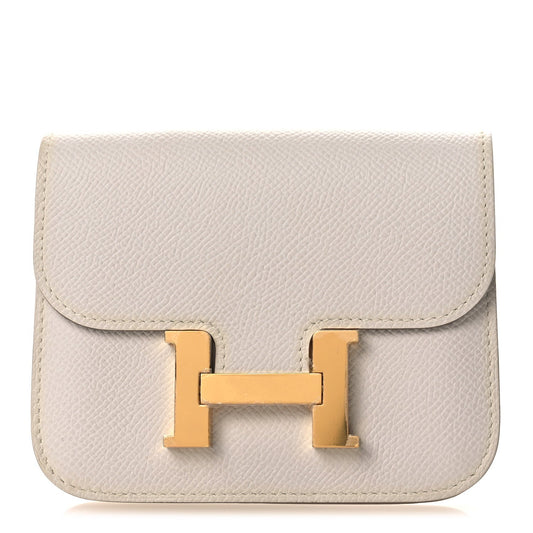 Pale gray leather slim wallet with centered gold-tone H clasp on front flap