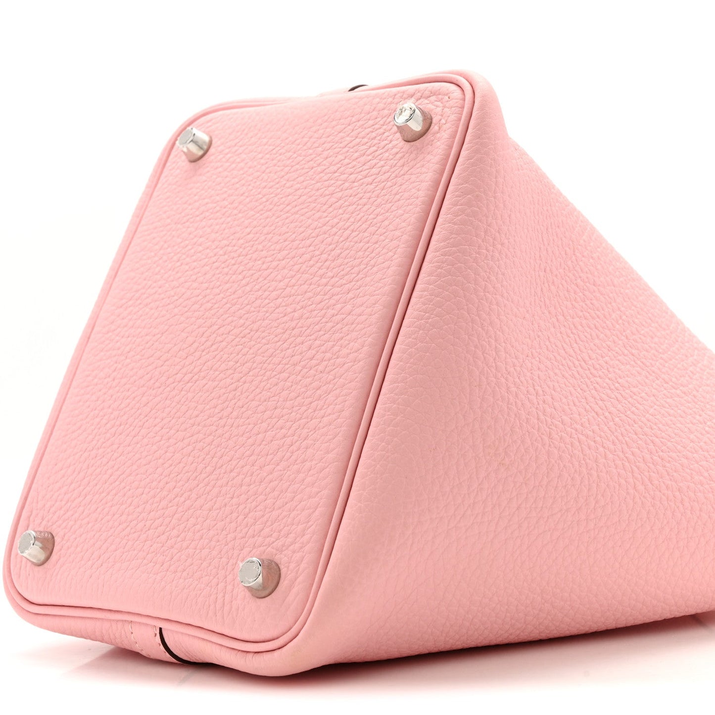 Rose pink leather handbag side view with snap studs along the fold