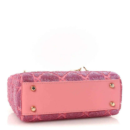 Mini Lady Dior handbag in light pink with front flap and gold button hardware