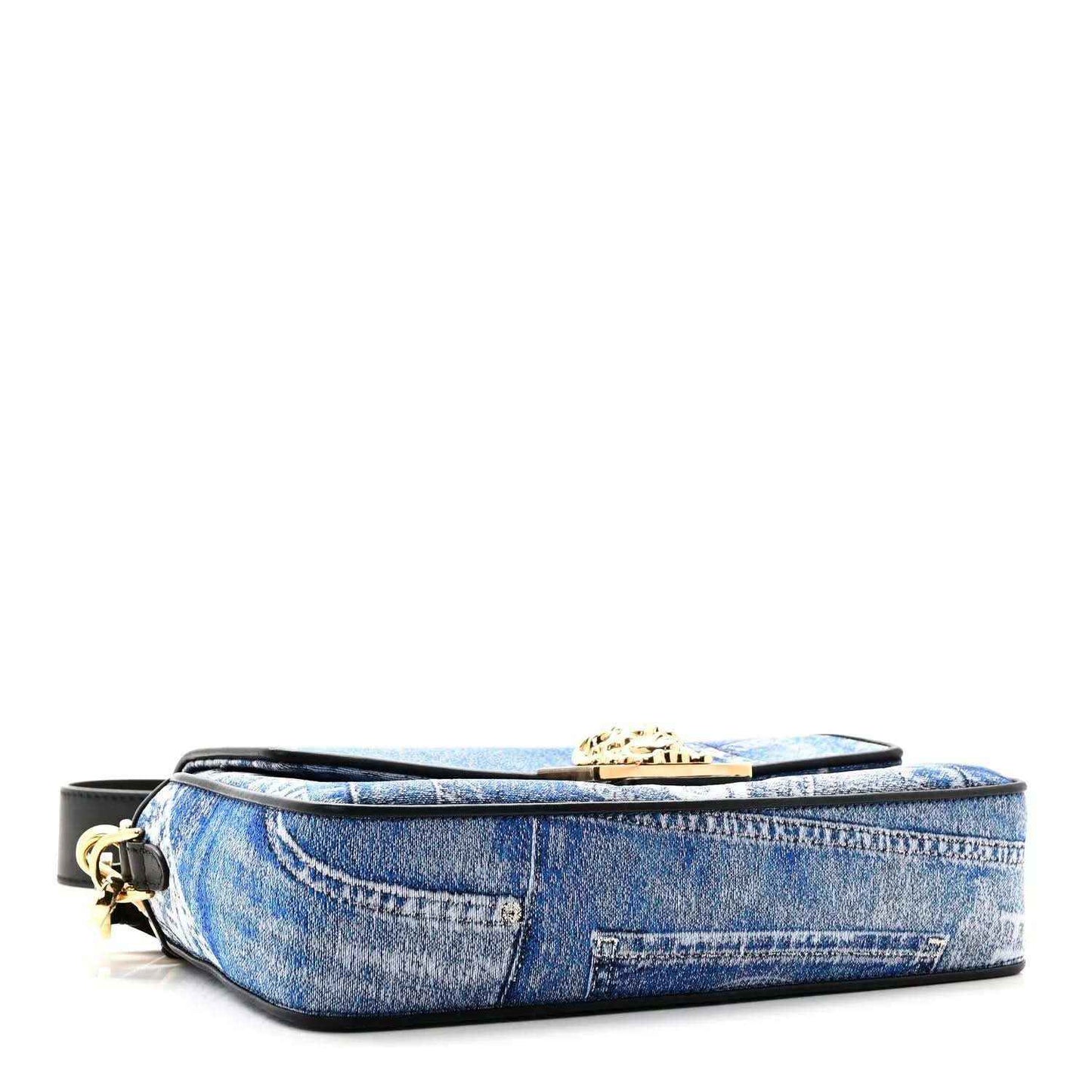 Blue denim baguette bag with black base strap and gold top clasp detail