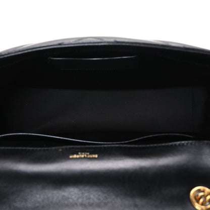Black leather shoulder bag interior with stitched lining under open front flap