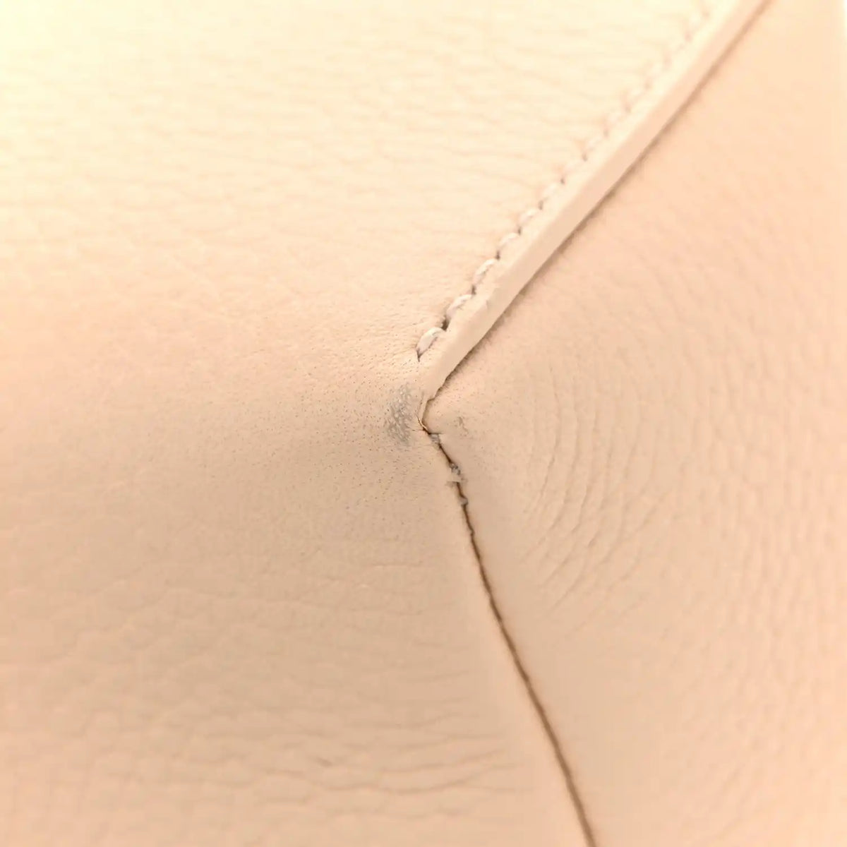 Cream leather pouch close-up of seam and stitching detail
