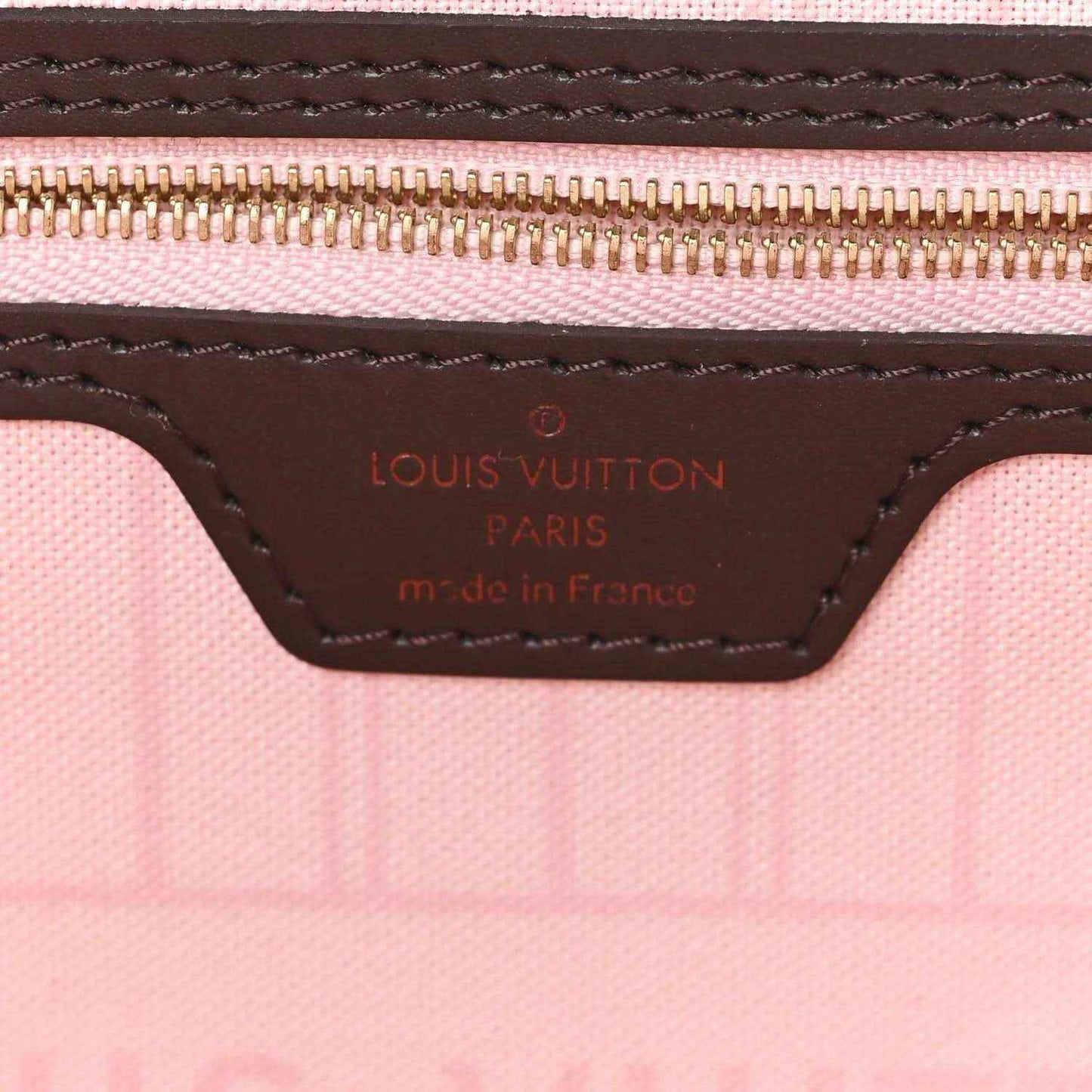 Louis Vuitton Damier Ebene tote bag interior label with stitched trim and zipper edge