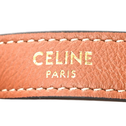 Tan leather strap trim with white contrast stitching and Celine Paris lettering