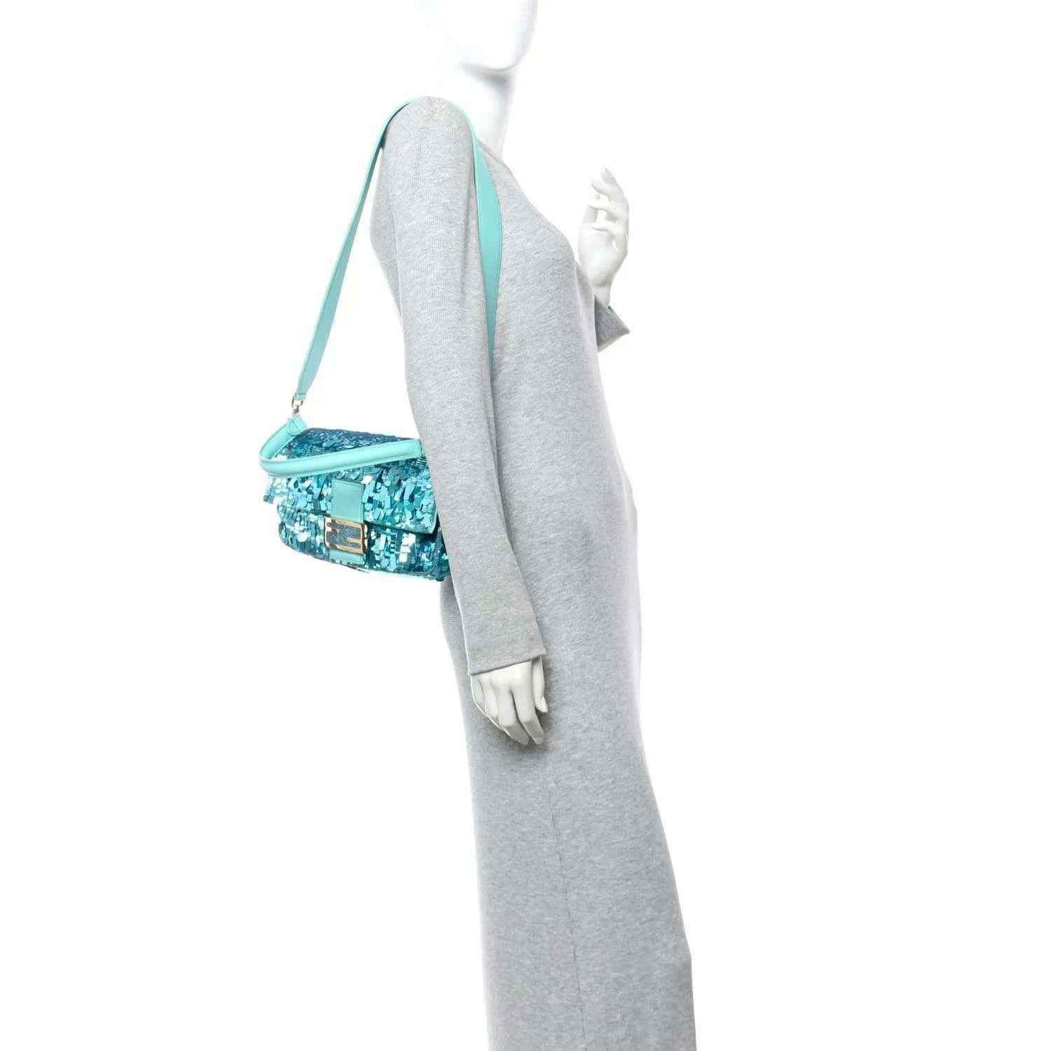 Turquoise sequin mini baguette bag with long crossbody strap, side view
