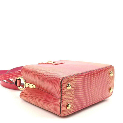 Louis Vuitton mini handbag bottom corner, fuchsia textured lizard, gold studs and strap.