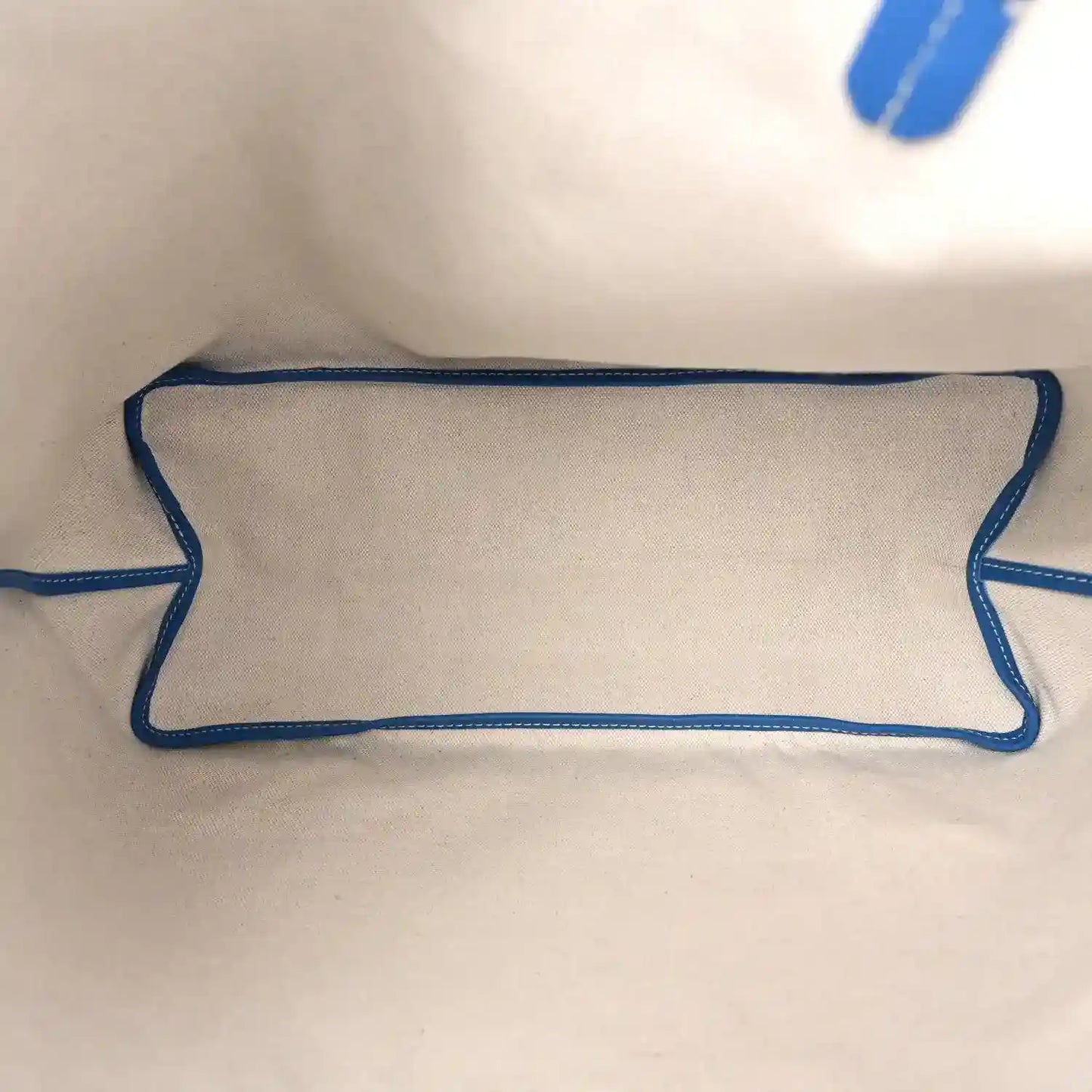 Sky blue interior pocket lining with stitched trim on tote bag