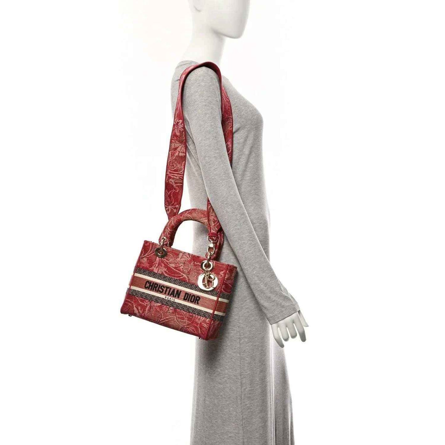 Pink embroidered canvas handbag with logo stripe and short shoulder strap on mannequin
