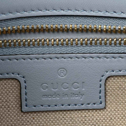 Light blue calfskin bag with gold zipper and stitched trim