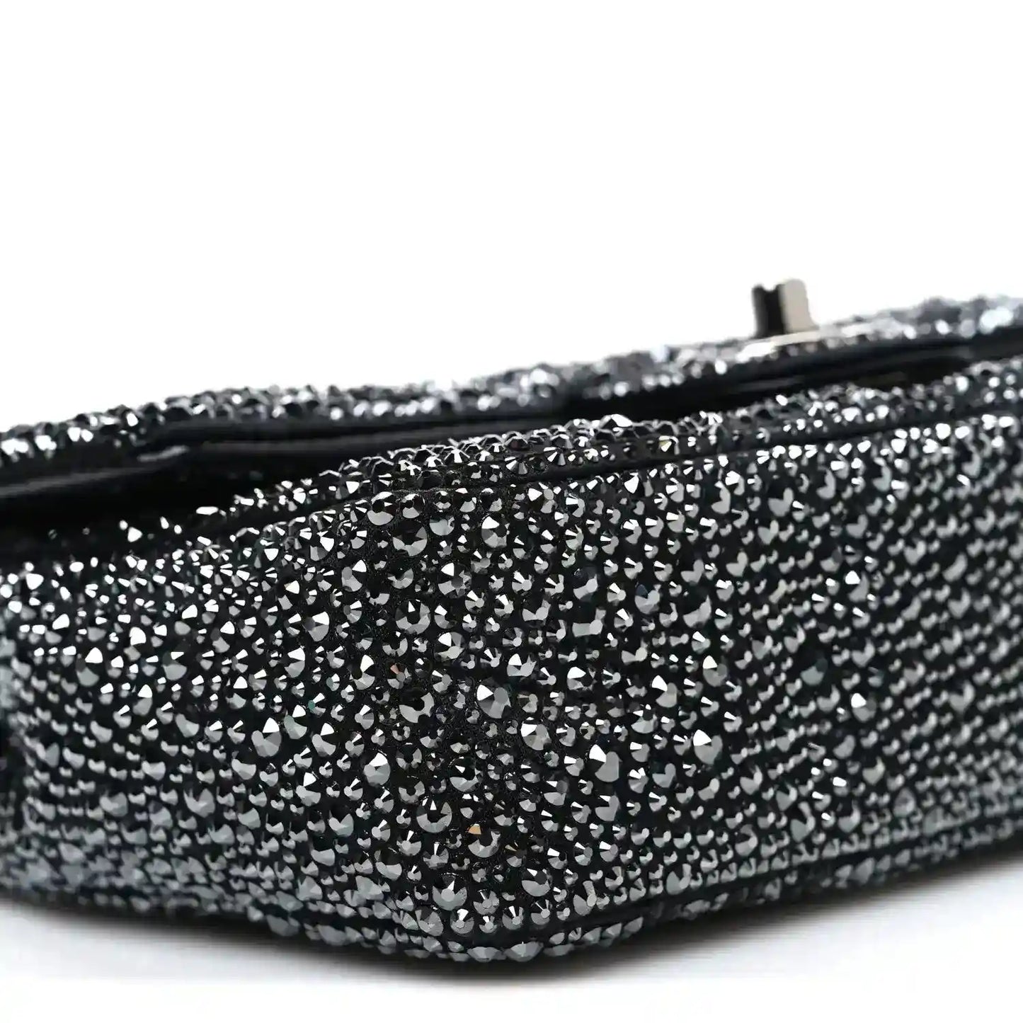 Black rhinestone small flap bag side with rounded bottom edge and zipper seam