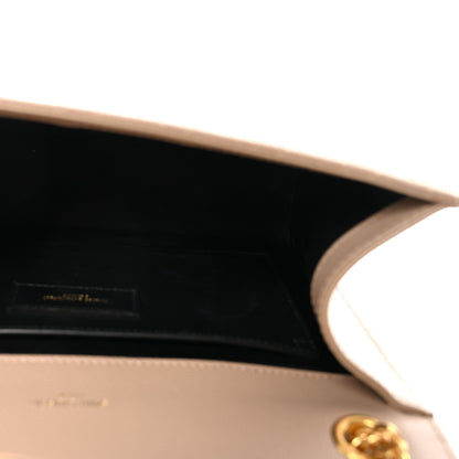 Satchel bag interior view with open top and smooth dark lining; gold-tone hardware visible.