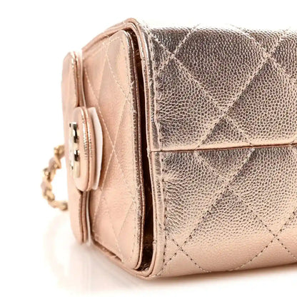 Copper metallic mini handbag side view with chain strap and quilted texture.