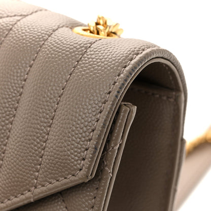 Top flap edge of quilted satchel with stitched panel
