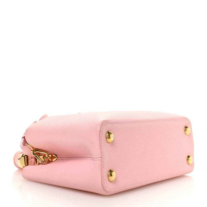 Bubble gum pink leather Capucines BB bag with flap top and gold turn-lock closure