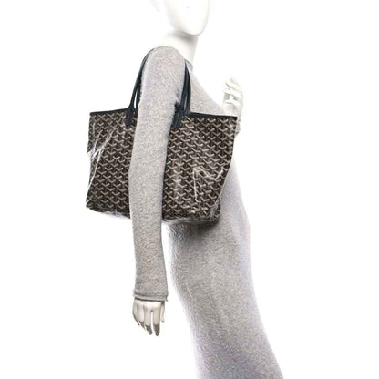 Black patterned tote bag with long handles and green side stripe