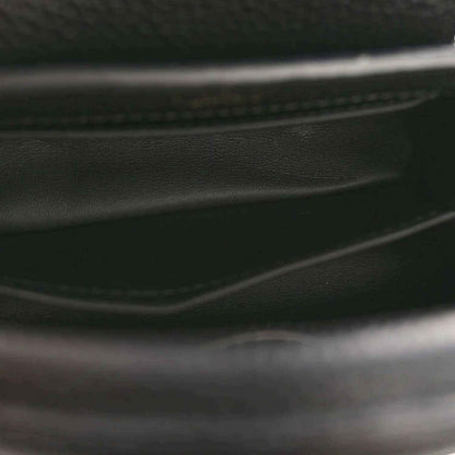 Black leather mini handbag close-up of stitched edge and interior trim