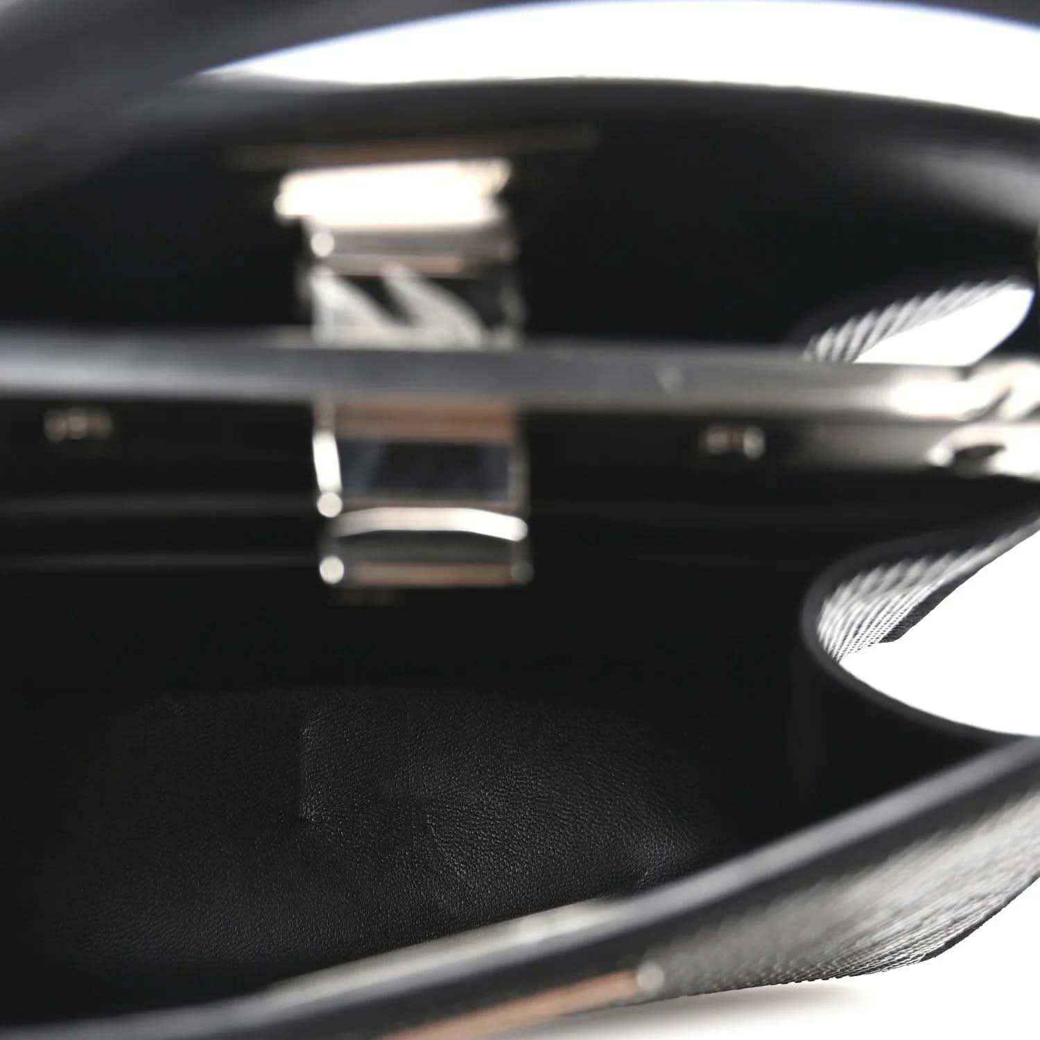 Black leather interior with engraved logo inside open satchel