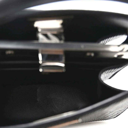 Black leather interior with engraved logo inside open satchel