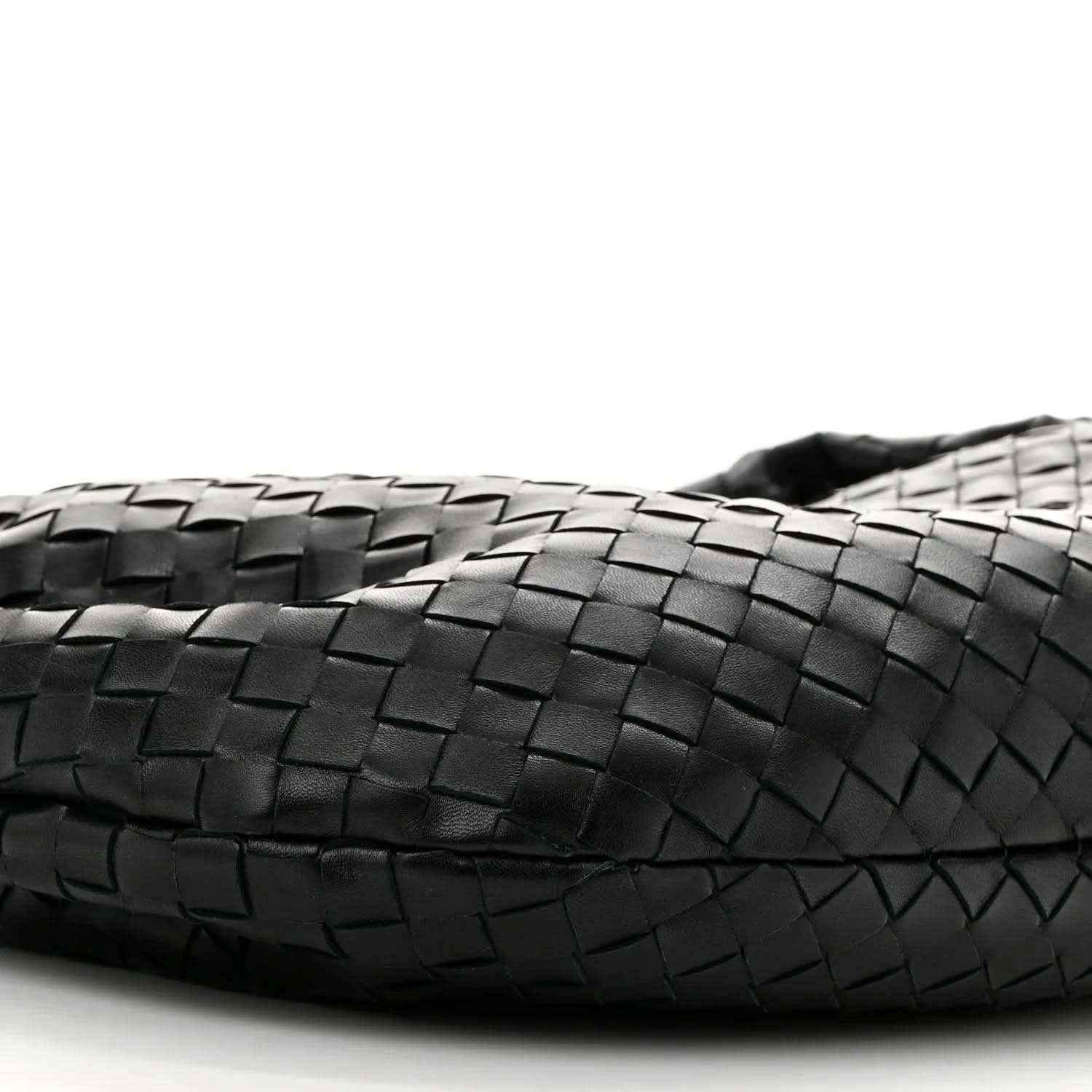 Black leather bag front with intrecciato weave detail and stitched edge
