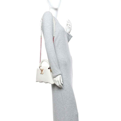 Louis Vuitton Capucines mini handbag, white, side view with shoulder strap