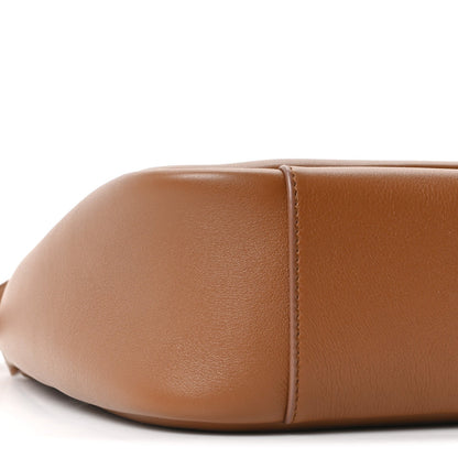 Tan leather hobo bag rounded side panel with visible seam