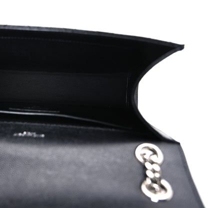 Satchel interior with black lining and silver chain hardware near the opening