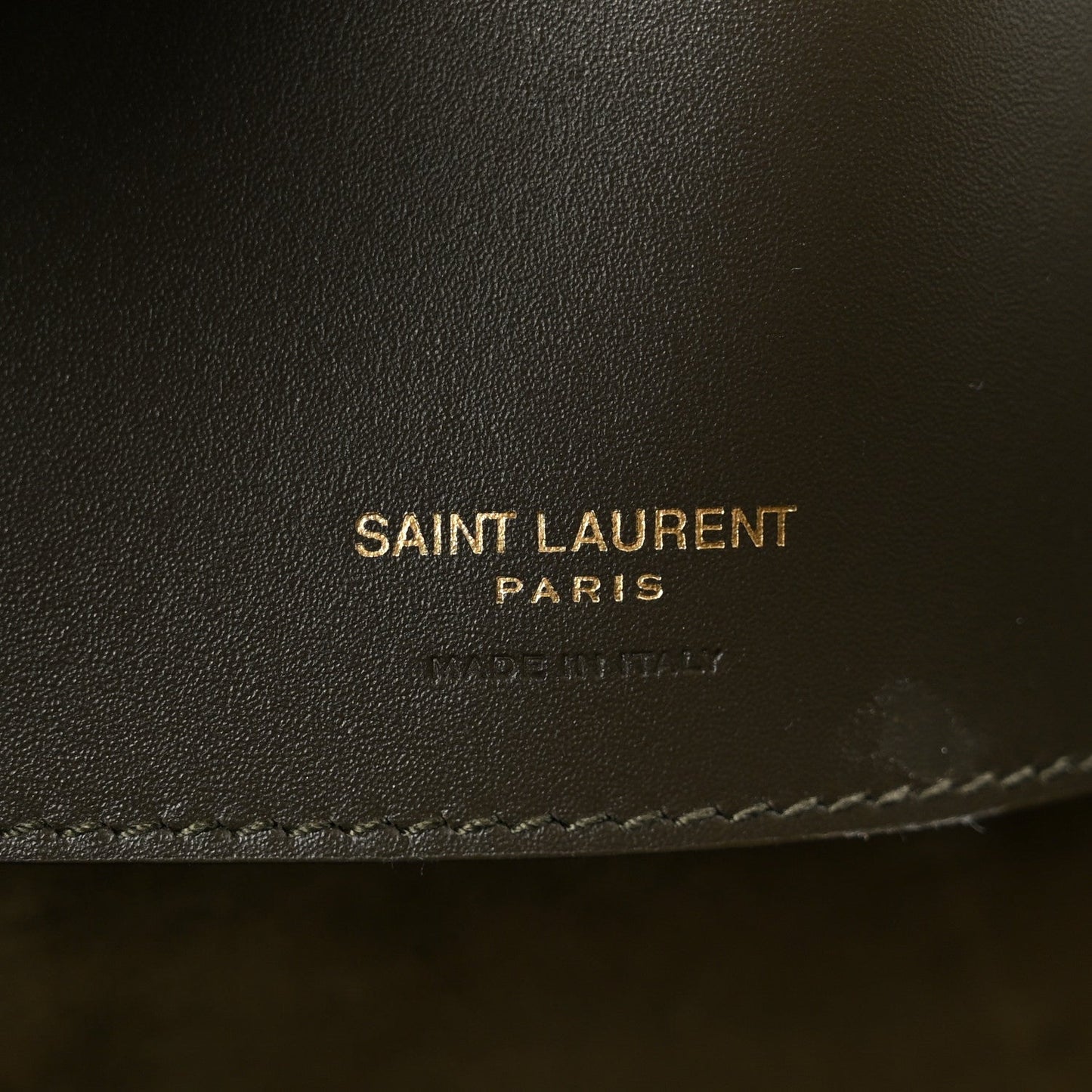 Saint Laurent leather bag imprint and stitched edge on deep musk calfskin.