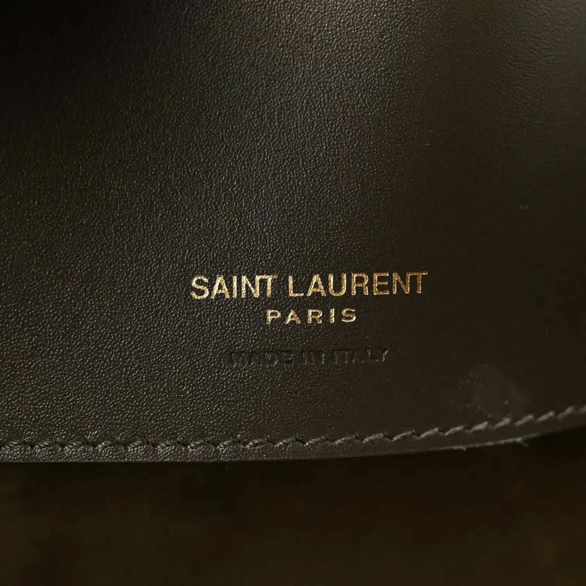 Saint Laurent leather bag imprint and stitched edge on deep musk calfskin.