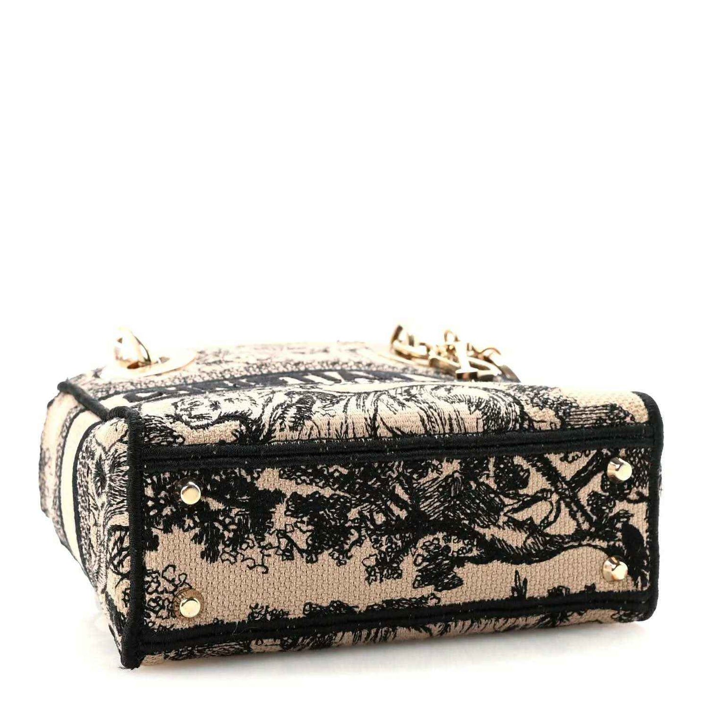 Mini embroidered handbag with top zip and gold-tone corner hardware, black-and-cream
