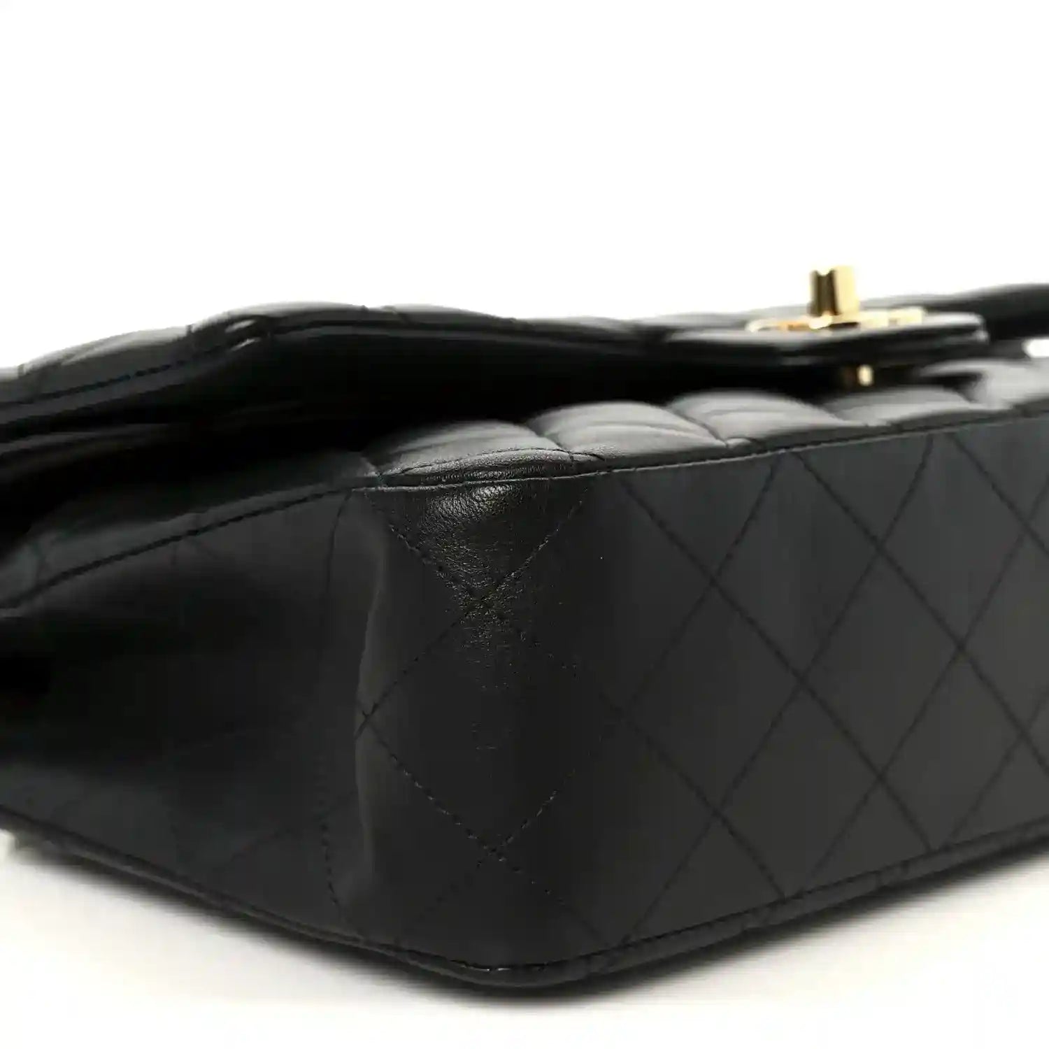 Chanel black quilted lambskin double flap bag side close-up with gold top hardware