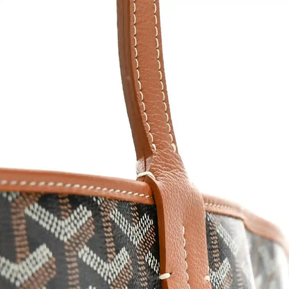 Black Goyardine canvas tote bag with upright leather handle and stitched trim