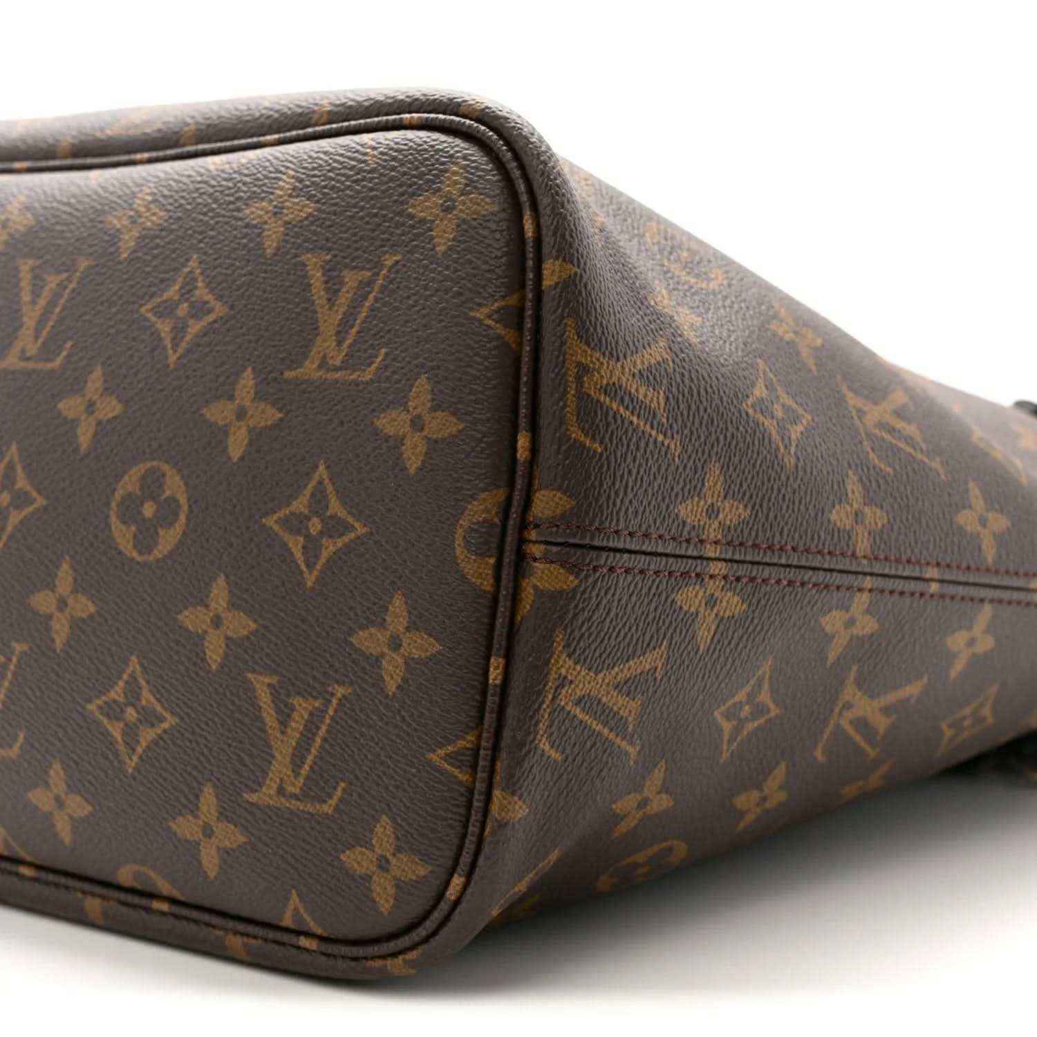 Monogram Louis Vuitton tote side with black piping, rounded edges, and stitching