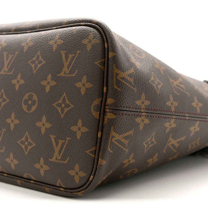 Monogram Louis Vuitton tote side with black piping, rounded edges, and stitching