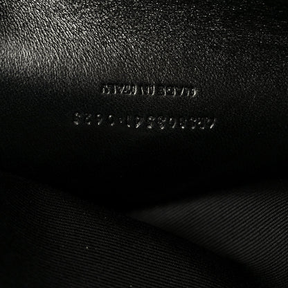 Black leather shoulder bag with embossed text and visible stitching