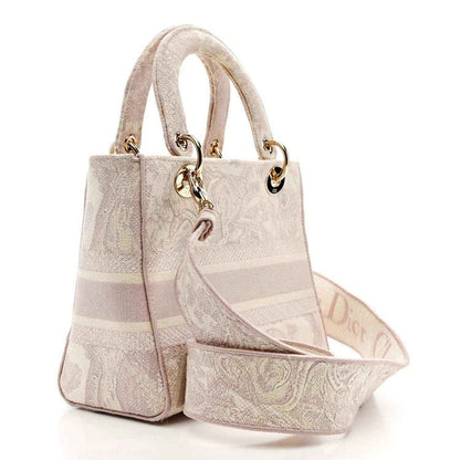 Medium rose-pink embroidered handbag with structured sides, two top handles, and gold hardware