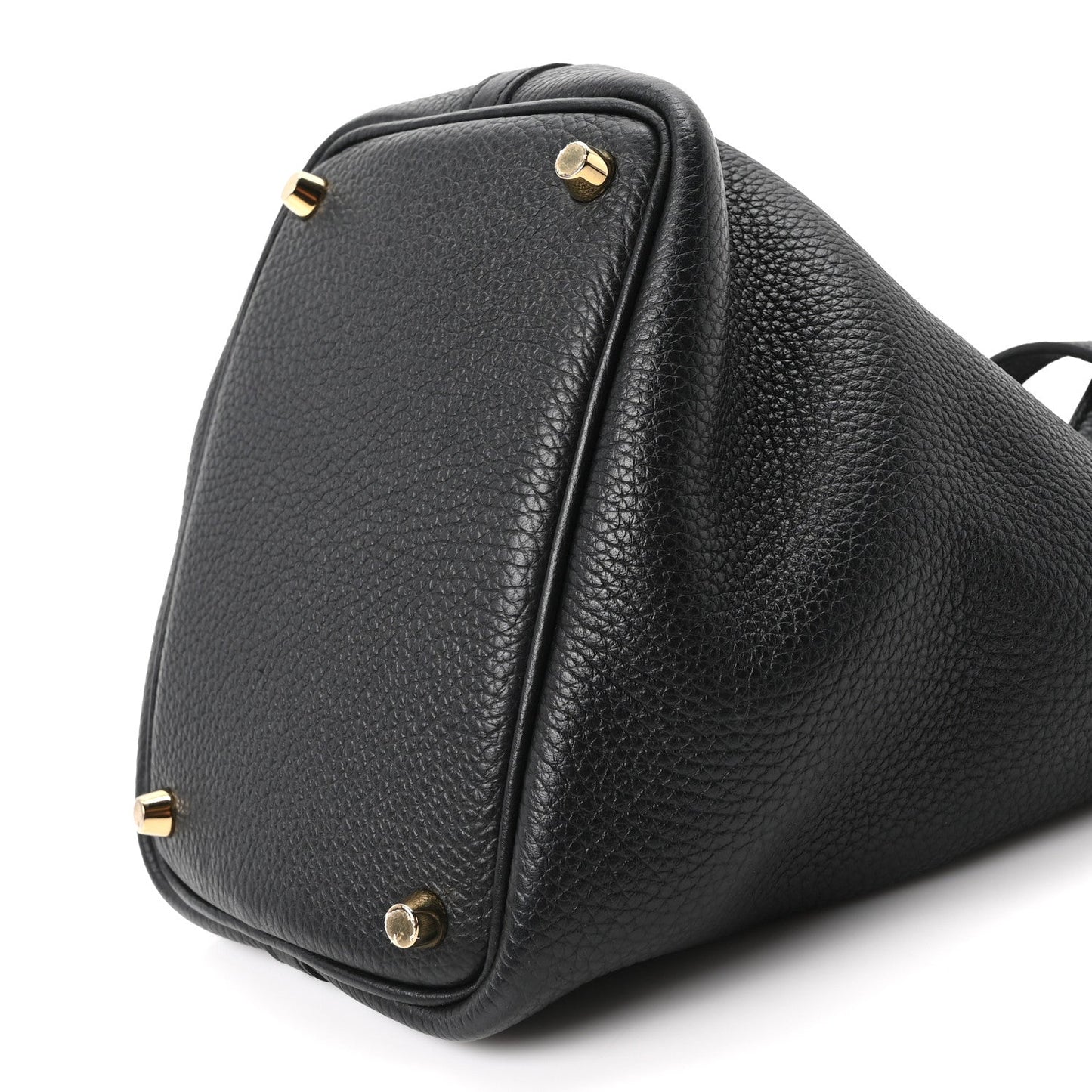 Black leather tote bag corner view with gold-tone studs and top handle loop