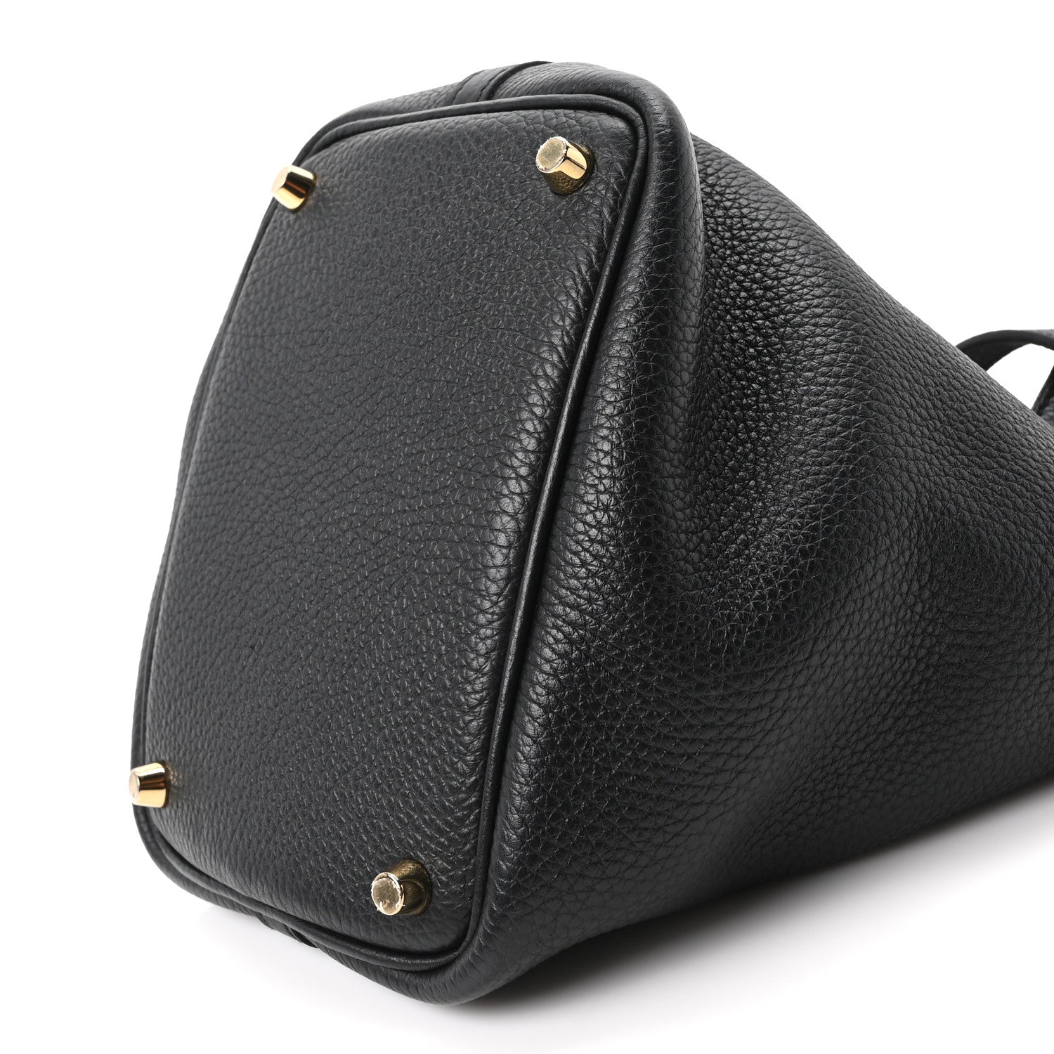 Black leather tote bag corner view with gold-tone studs and top handle loop