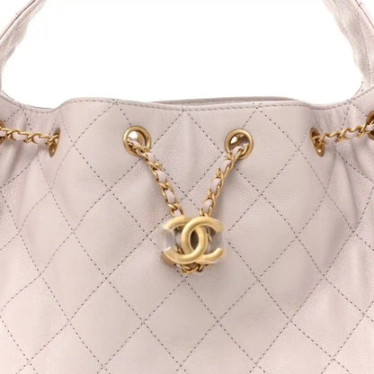 Lilac quilted handbag top with gold chain straps and interlocking CC emblem