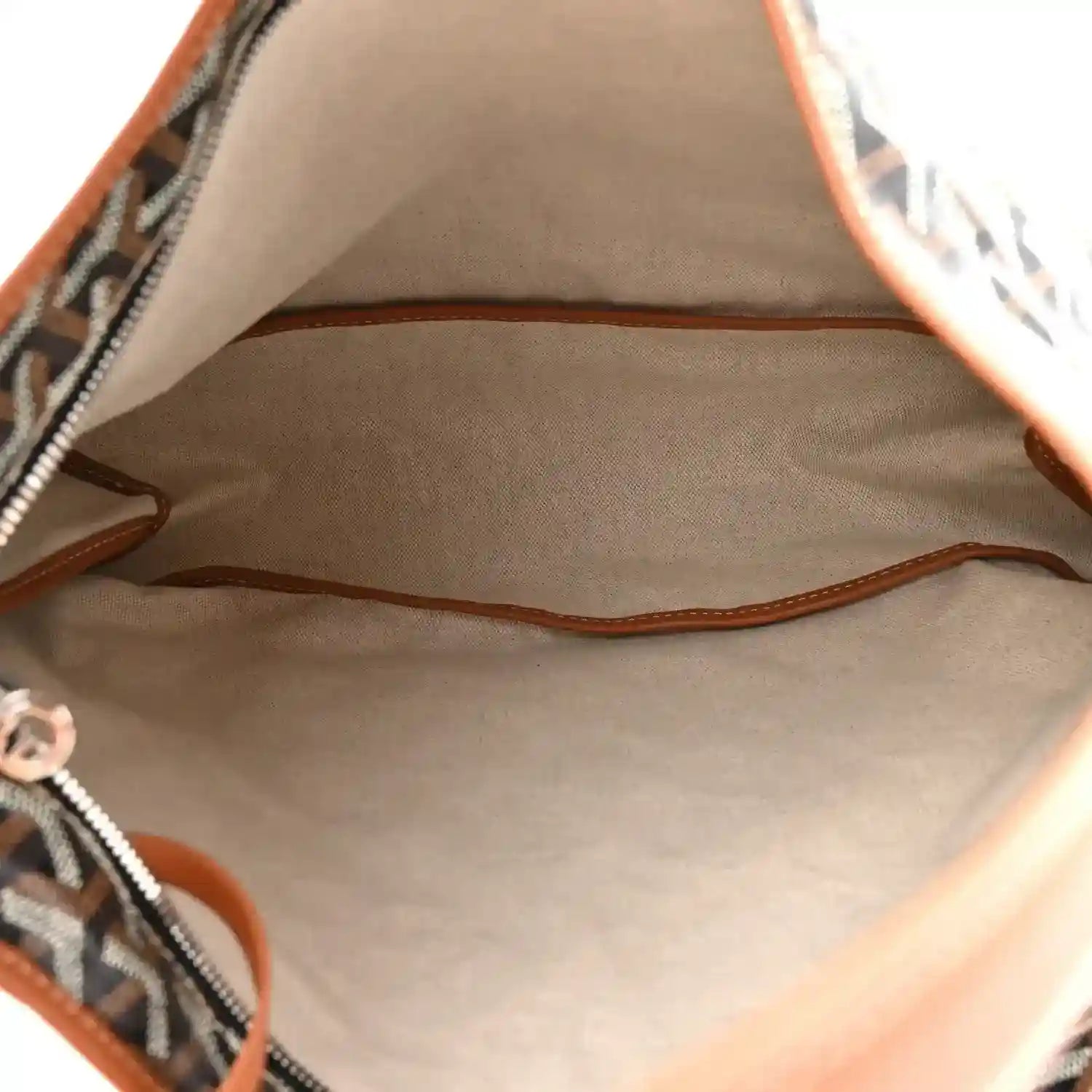 Goyard hobo bag interior view with brown leather trim around the opening