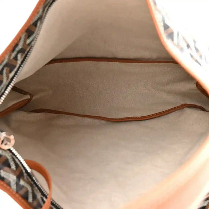 Goyard hobo bag interior view with brown leather trim around the opening