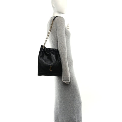 Black quilted leather shoulder bag on chain strap, side profile