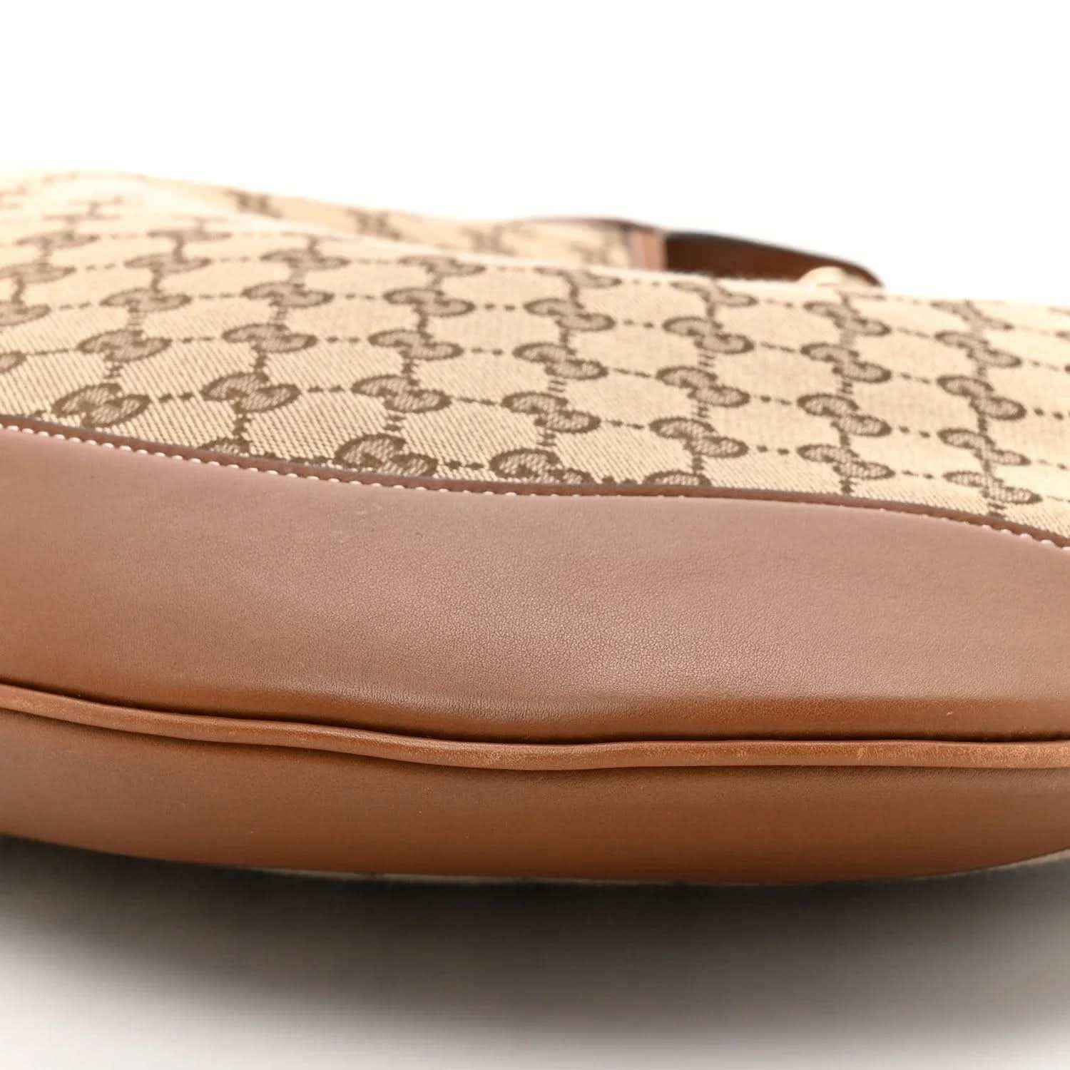 Canvas top edge with stitched brown leather trim on GG monogram shoulder bag