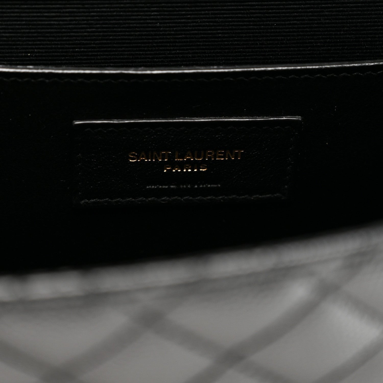 Black satchel inner label area with Saint Laurent text on flap