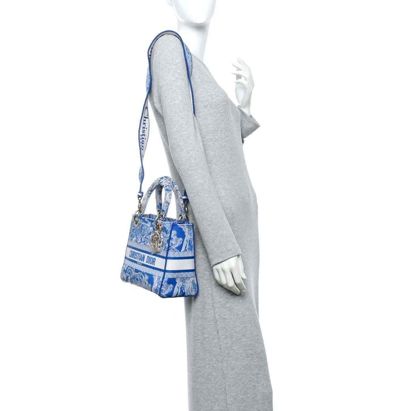 Dior tote bag in bright blue Toile de Jouy print worn over shoulder
