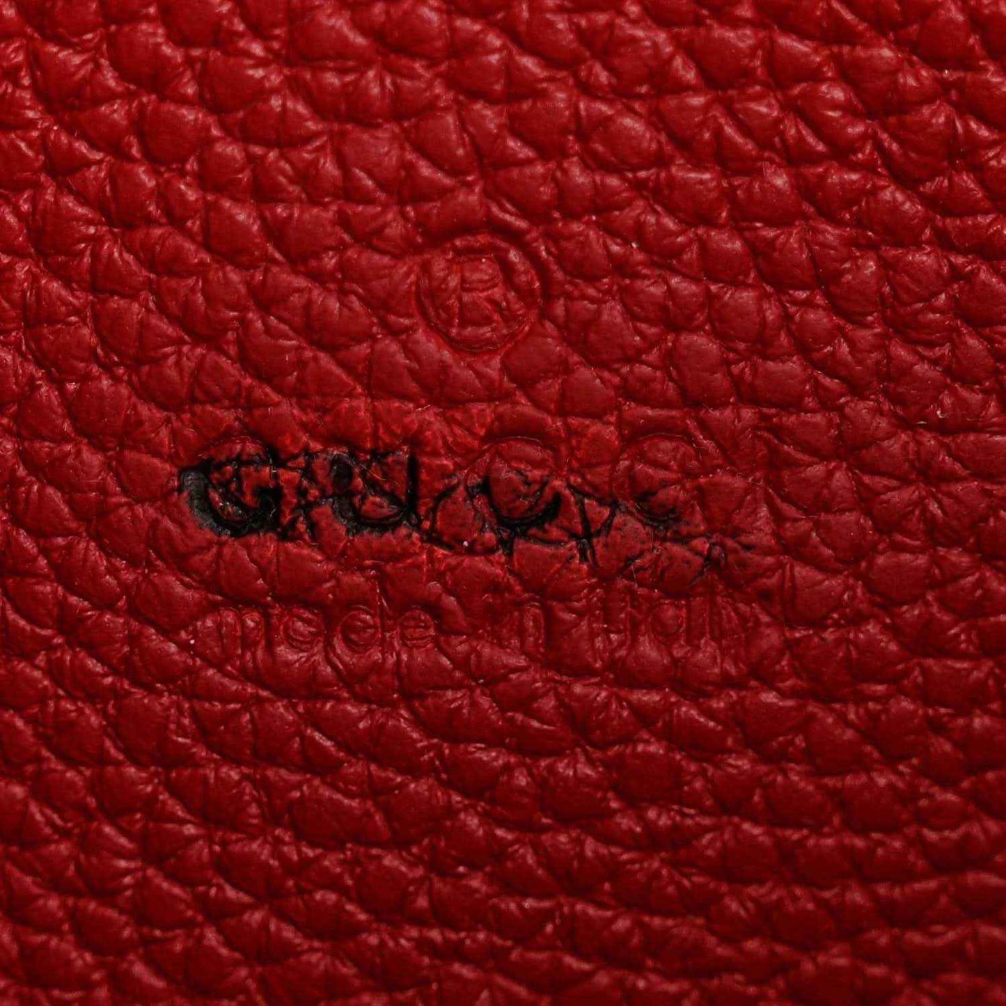 Red pebbled leather with embossed script logo