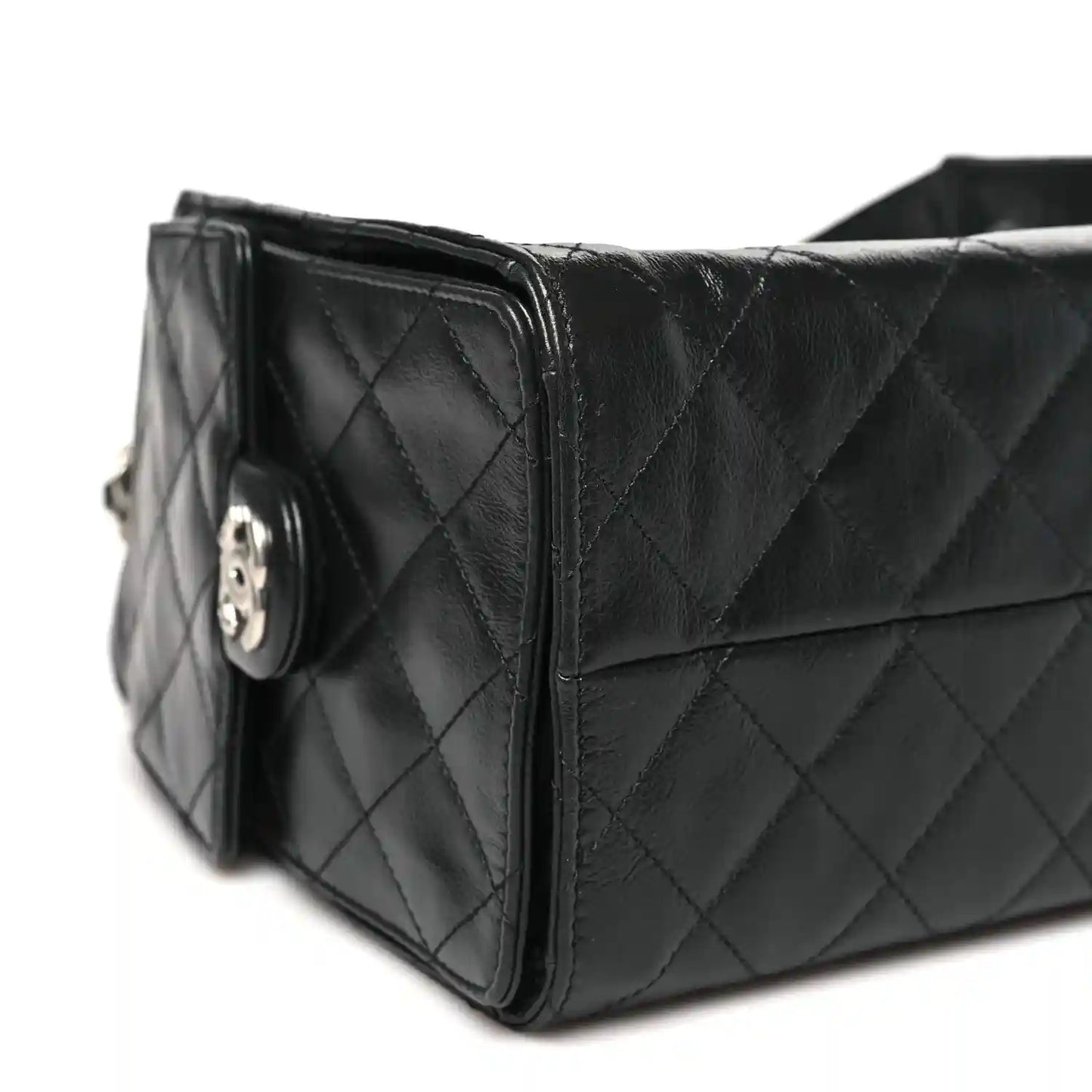 Chanel black quilted leather handbag side view with logo detail on clasp