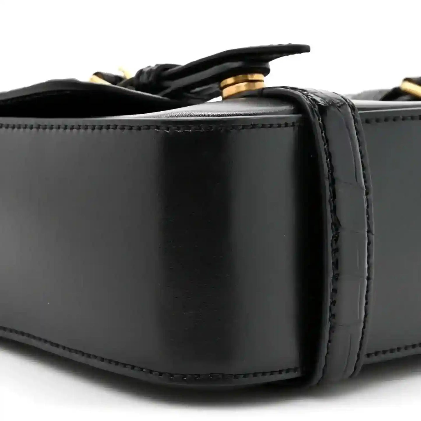 Black leather messenger bag close-up of top edge and strap attachment hardware